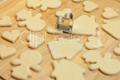 cut dough snowman, house, heart, and forms for cookies