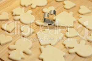 cut dough snowman, house, heart, and forms for cookies