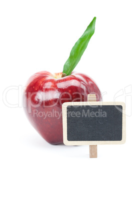 red apple with green leaf and a board isolated on white