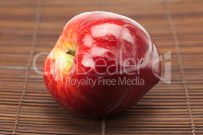 red apple on a bamboo mat