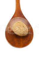 walnut in a wooden spoon isolated on white