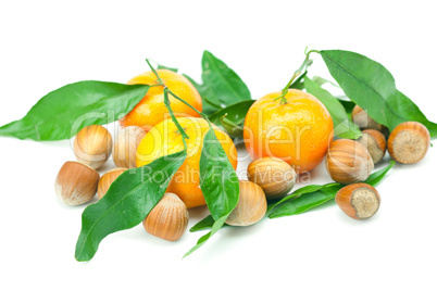 mandarin with green leaves and nuts  isolated on white