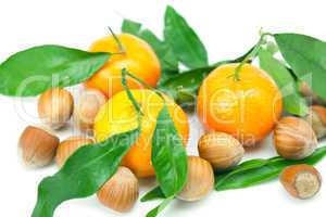 mandarin with green leaves and nuts  isolated on white