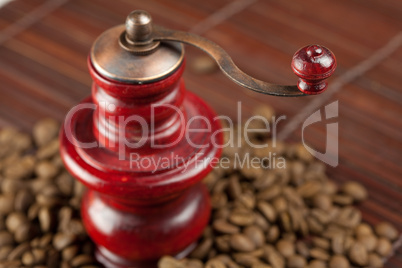 coffee grinder and coffee beans on a bamboo mat