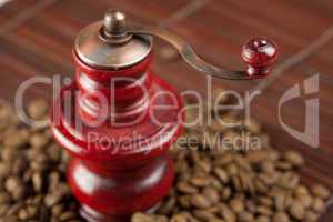 coffee grinder and coffee beans on a bamboo mat