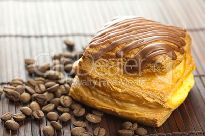 cake with chocolate and coffee beans lying on a bamboo mat