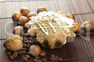 cake with icing, coffee beans and nuts lying on a bamboo mat