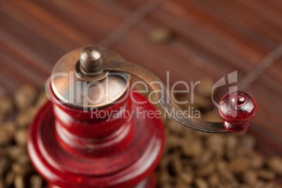 coffee grinder and coffee beans on a bamboo mat