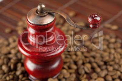 coffee grinder and coffee beans on a bamboo mat