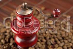 coffee grinder and coffee beans on a bamboo mat