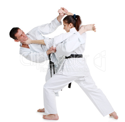 Karate. Young girl and a men in a kimono. Battle sports capture