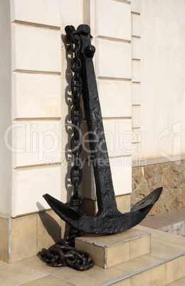 Black ship's anchor near the old wall