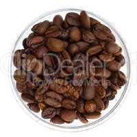 Natural coffee beans heap in transparent glass bowl, isolated on