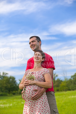 Husband hugs his pregnant