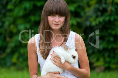 Teenage girl holding white rabbit