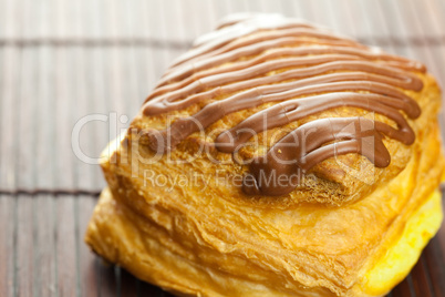 cake with chocolate lying on a bamboo mat