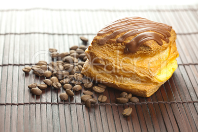 cake with chocolate and coffee beans lying on a bamboo mat