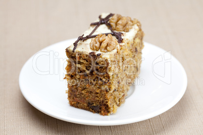 Piece of cake with nuts lying on the plate