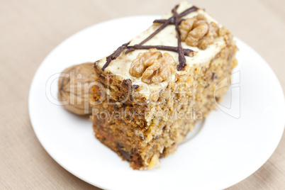 Piece of cake with nuts lying on the plate