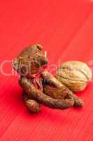 Teddy bear handmade and nuts on a red background
