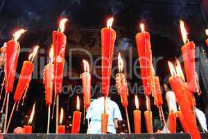 Joss sticks and candles burning at a temple