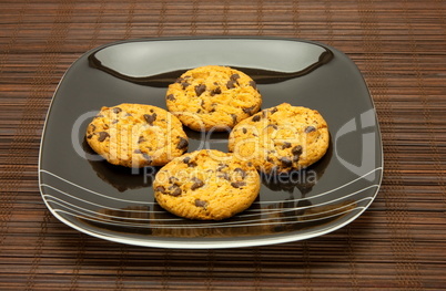 plate of cookies on dark brown background