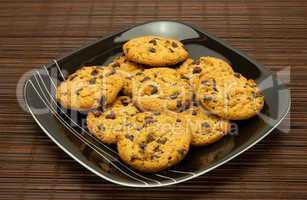 plate of cookies on dark brown background