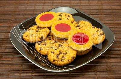 plate of cookies on dark brown background