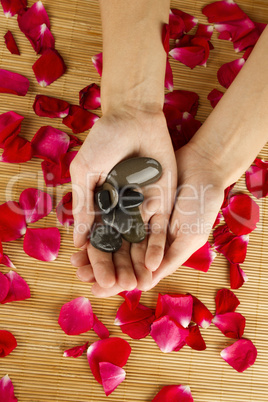 Hands on rose petals