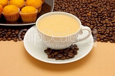 White cup of coffee and coffee beans