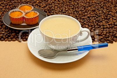 White cup of coffee and coffee beans