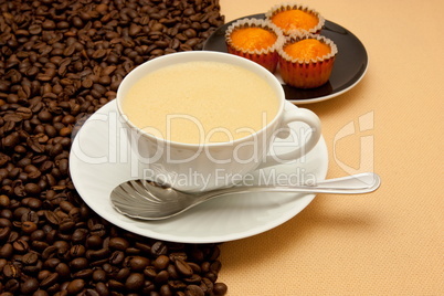 White cup of coffee and coffee beans