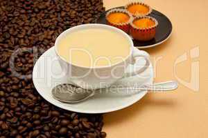 White cup of coffee and coffee beans