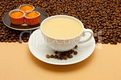 White cup of coffee and coffee beans