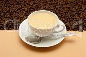 White cup of coffee and coffee beans