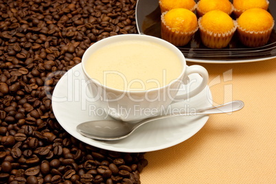 White cup of coffee and coffee beans