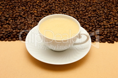 White cup of coffee and coffee beans