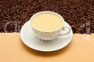 White cup of coffee and coffee beans