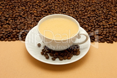 White cup of coffee and coffee beans