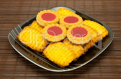 plate of cookies on dark brown background