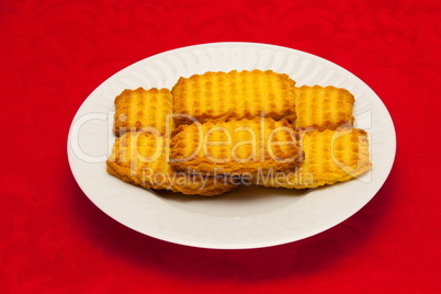 plate of cookies on red background