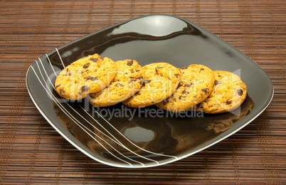 plate of cookies on dark brown background