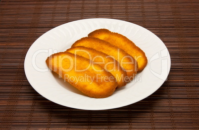 plate of cookies on dark brown background