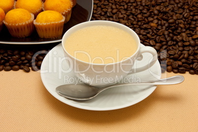 White cup of coffee and coffee beans