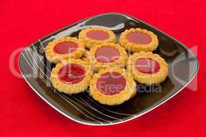 plate of cookies on red background