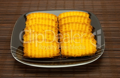 plate of cookies on dark brown background