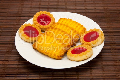 plate of cookies on dark brown background