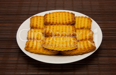 plate of cookies on dark brown background