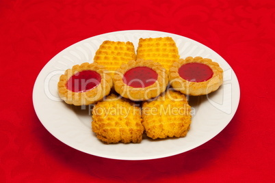 plate of cookies on red background