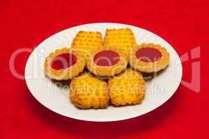 plate of cookies on red background